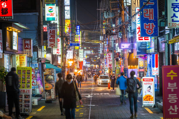 Seoul neon nights crowded shopping streets downtown cityscape Korea 5 People walking through the neon lit night streets of Sinchon in the heart of Seoul, South Korea’s vibrant capital city. kangnamgu stock pictures, royalty-free photos & images