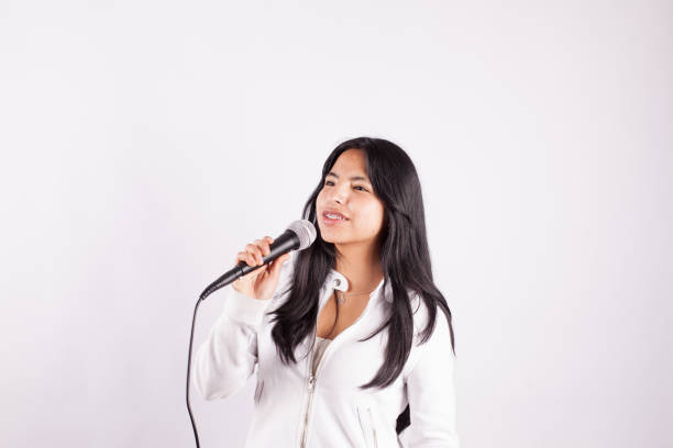 istock young woman singing with a microphone 1507131716