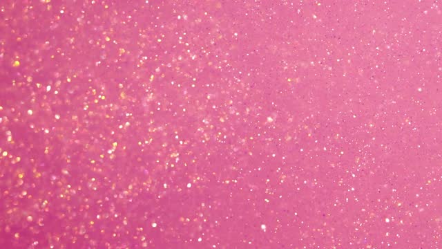 Abstract sparkling dust particles slow motion in fluid.