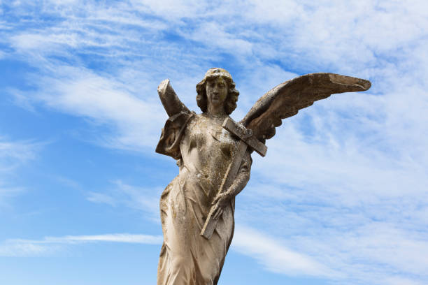 istock cherub with one arm and one wing holding the cross 1507213454