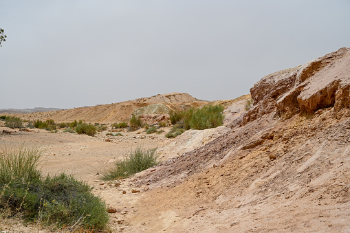 Beautiful dry landscape with colorful sand and cloudy skies in the Negev desert in Israel. A high resolution.
