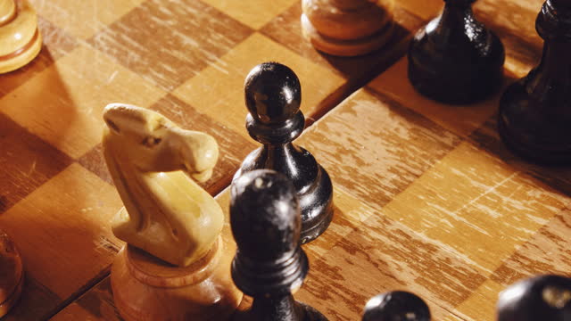 Playing with old chess pieces in the middlegame. Chess board with retro pieces, stop motion