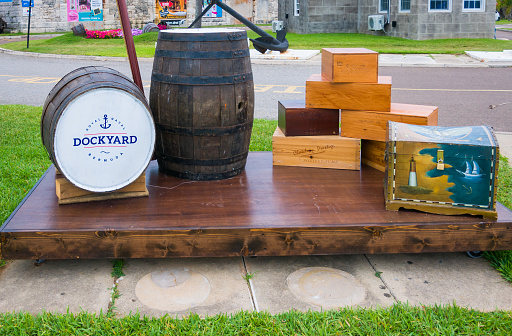 Royal Naval Dockyard, Bermuda- May 24, 2022- A display of wooden crates and barrels greet cruise ship visitors who are docking  at the Royal Naval Dockyard.  Often a local docent is available to answer tourist questions,
