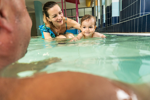 Happy family having fun at the swimming pool