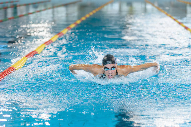 istock Front view of a female swimmer performing butterfly technique 1507219310