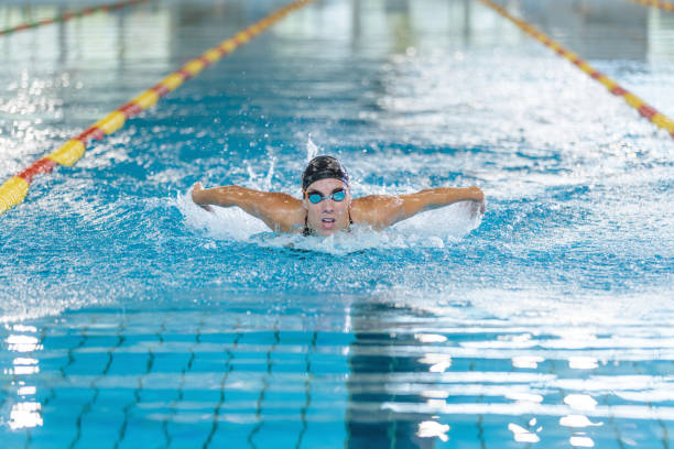 istock Front view of a female swimmer performing butterfly technique 1507220150