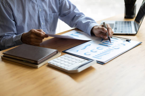 istock Businessman working with laptop and analyzing charts on financial documents with calculator. 1507221058