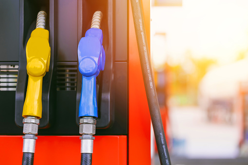 fuel gas station, closeup gasoline fuel nozzle petroleum benzine and diesel or gasohol colors type.