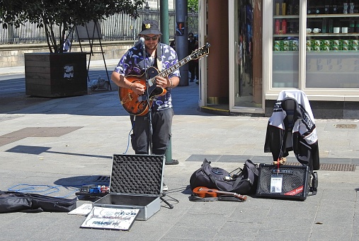 29th May 2023, Dublin, Ireland. People watching a busker on Grafton Street.