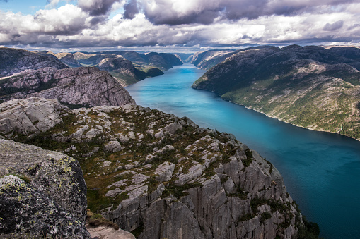 Preikestolen or Prekestolen or Pulpit Rock is a famous tourist attraction near Stavanger, Norway. Preikestolen is a steep cliff which rises above the Lysefjord. High quality photo