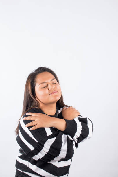 istock latina woman hugging herself. 1507230157