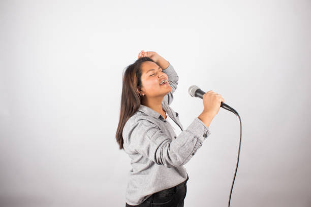 istock Latin woman singing passionately with a microphone. 1507231612