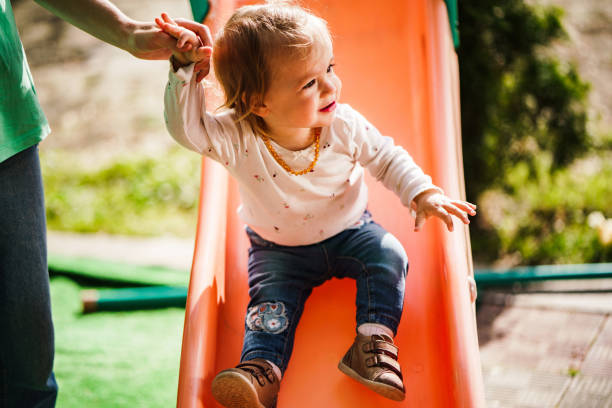 istock Small girl sliding at the playground 1507241684