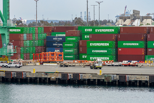 San Pedro, CA, USA – June 2, 2023: Semi trucks and shipping containers at Terminal Island with located at the Port of Los Angeles in San Pedro, California.