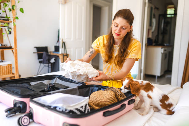 istock Young woman packing her suitcase for vacation 1507265775