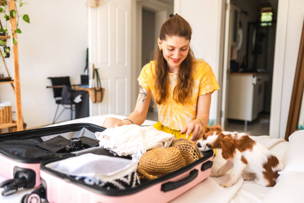 istock Young woman unpacking her suitcase for vacation 1507266341