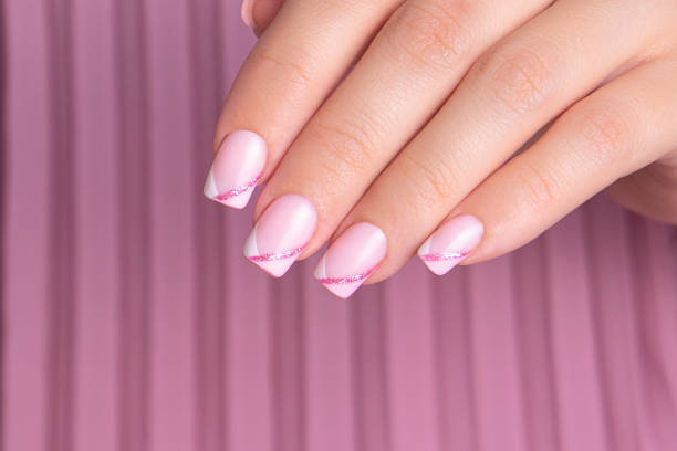 istock Female hand with pink and white manicure nails 1507277423