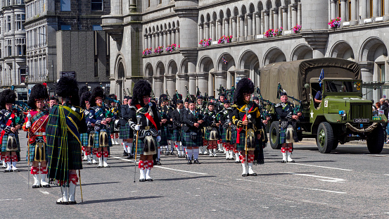 Aberdeen, Scotland, UK - 1st July, 2023 : Marching pipe bands join military personnel, veterans and cadets taking part in a parade along Union Street, Aberdeen, to mark Armed Forces day 2023 in the UK.