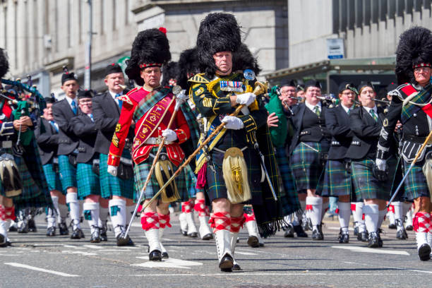 Aberdeen, Scotland, UK - 1st July, 2023 : Marching pipe bands join military personnel, veterans and cadets taking part in a parade along Union Street, Aberdeen, to mark Armed Forces day 2023 in the UK.