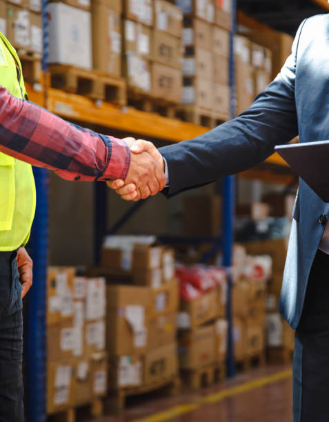 istock Efficient Collaboration in an Industrial Factory Warehouse: Businessman Engaging with Worker and Engineer, Exchanging Handshake 1507301534