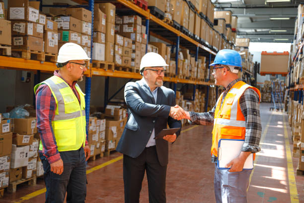 istock Efficient Collaboration in an Industrial Factory Warehouse: Businessman Engaging with Worker and Engineer, Exchanging Handshake 1507301544
