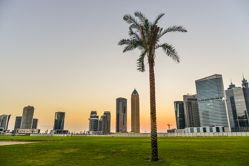 Dubai, UAE - Dec 9, 2018. Modern buildings at sunset in Dubai, UAE. Dubai is a global city and business hub of the Middle East.