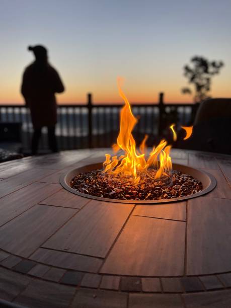 istock Closeup of a flickering fire pit on a wooden deck with a blurry background 1507316962