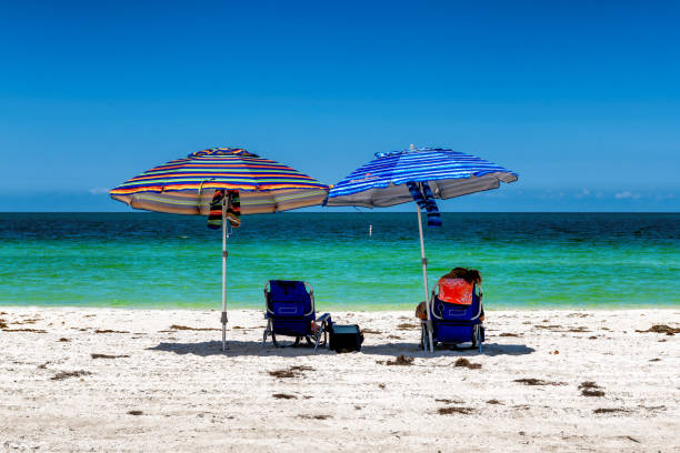 istock Sunny beach with colorful umbrella and beach chairs in tropical beach 1507336465