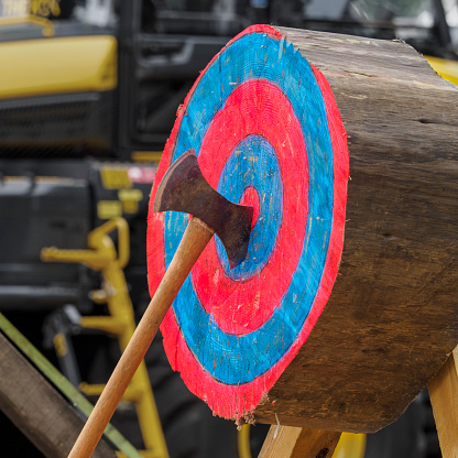An axe buried in the bullseye of a target during an axe-throwing competition