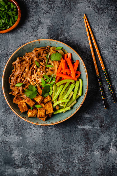 istock Soba noodles with vegetables and fried tofu in a bowl. 1507383949