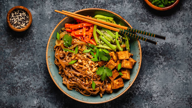 istock Soba noodles with vegetables and fried tofu in a bowl. 1507387413