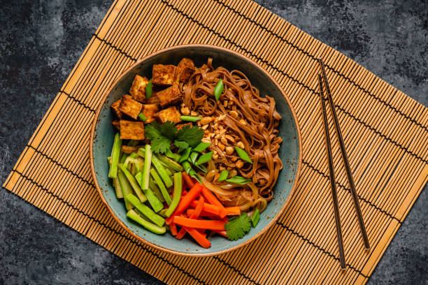 istock Soba noodles with vegetables and fried tofu in a bowl. 1507387414