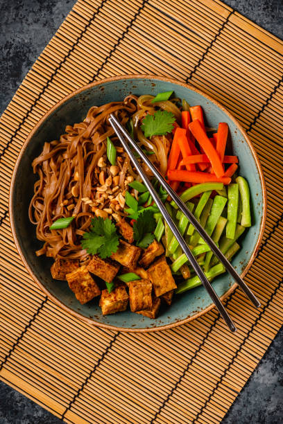 istock Soba noodles with vegetables and fried tofu in a bowl. 1507387415