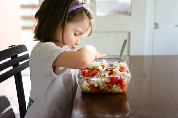 istock Child eating salad at home 1507391311