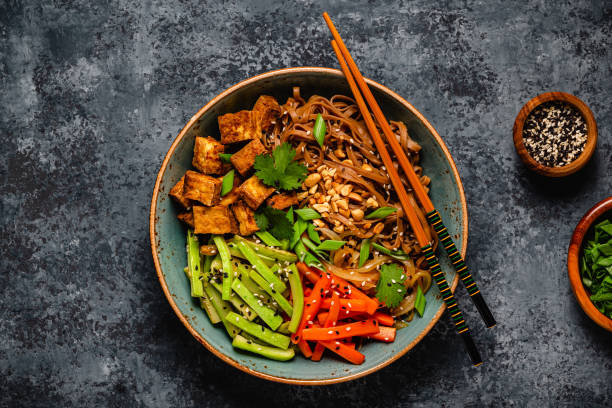 istock Soba noodles with vegetables and fried tofu in a bowl. 1507392009