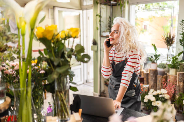 istock Woman is working in flower shop taking orders from customers 1507435701