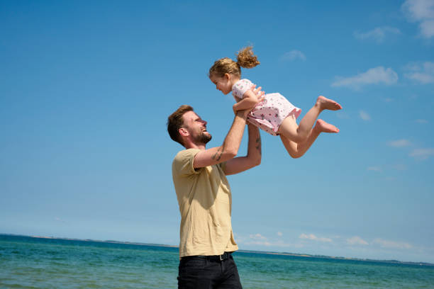 istock Father and daughter playful on beach 1507469762
