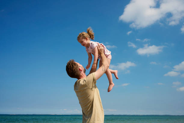 istock Father and daughter playful on beach 1507481539