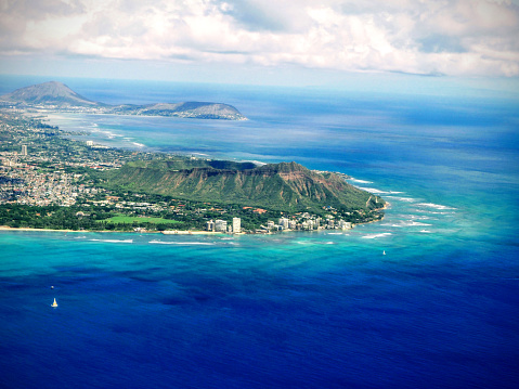 Embark on a visual journey as you soar high above Oahu, Hawaii, capturing an awe-inspiring aerial view of its magnificent landscapes. This captivating shot showcases the iconic Diamondhead, the lush greenery of Kapiolani Park, the vibrant energy of Waikiki, the historic Natatorium, the charming town of Kapahulu, and the vast expanse of the Pacific Ocean.