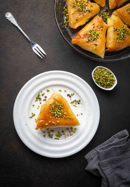 istock Traditional Turkish desserts; custard triangular dessert, albanian dessert ( Turkish name; Arnavut tatlisi or muhallebili muska tatlisi) 1507490315