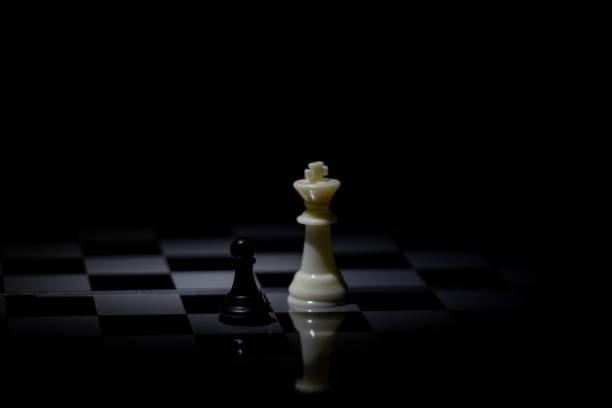 istock chess pieces on a chessboard in a dark room illuminated by a lamp 1507562129