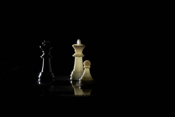 istock chess pieces on a chessboard in a dark room illuminated by a lamp 1507562665