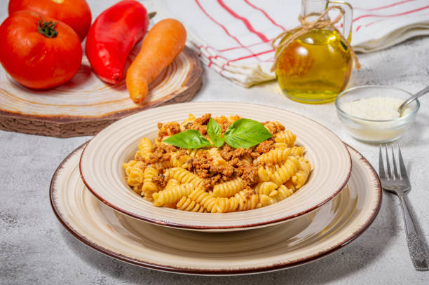 istock Fusilli pasta with minced meat, tomato sauce, cheese and basil 1507567506