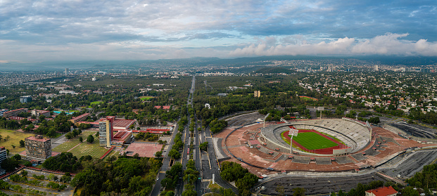 Cityscape of the south of Mexico City with the campus of the National Autonomous\nUniversity and its stadium
