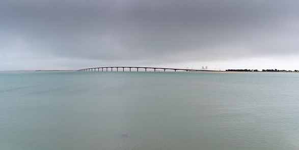 Panorama with Ile de Re bridge over the sea with fog on a winter day. view from Rivedooux