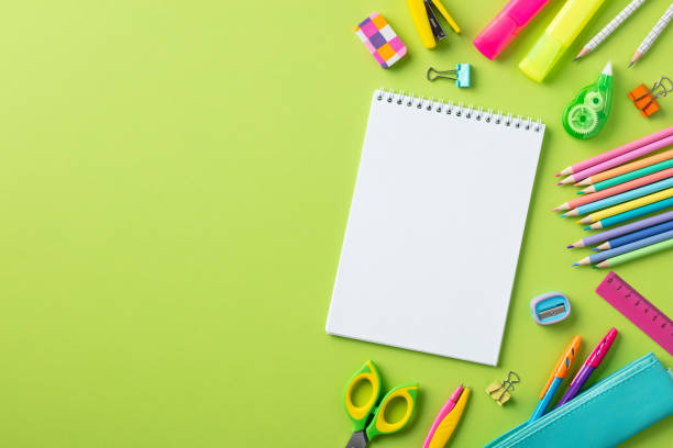 istock Back to school concept. Empty notepad with school stationery on green background. 1507633875