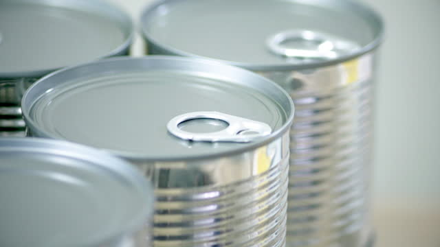 Metal cans on production line in manufacturing plant.