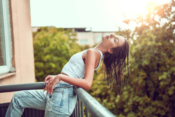 istock Female Leaning On Balcony And Drying Hair After Bath 1507647699