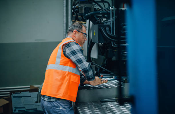 istock Male apprentice engineer working with CNC machine in factory 1507649853