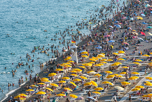 Aerial view of Konyaaltı Beach Antalya, Turkey. Crowd of people swimming in the sea and sunbathing on the beach